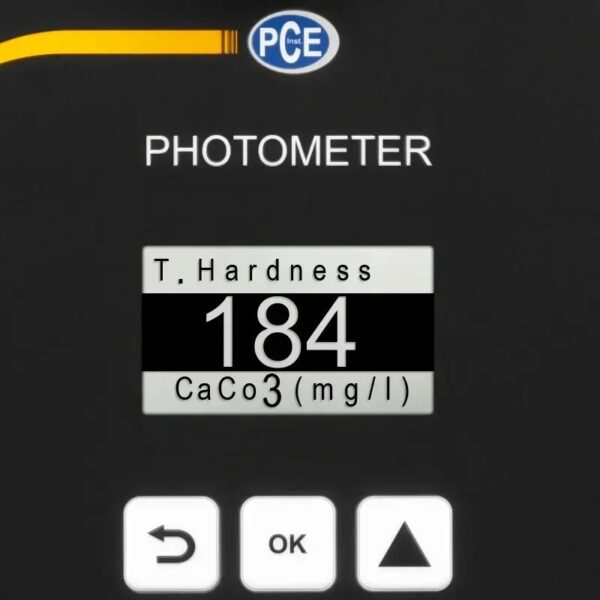 A close-up of a digital photometer display showing a total hardness measurement of 184 mg/L CaCO3. The unit has a black background with white text and three buttons at the bottom labeled "OK," a left arrow, and an up arrow. The PCE logo is visible at the top.