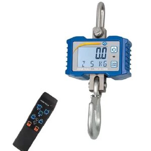 A blue and silver digital crane scale with a large hook, manufactured by PCE. The scale features an LCD screen displaying "0.0". To the left of the scale is a black remote control with multiple buttons for operating the device.